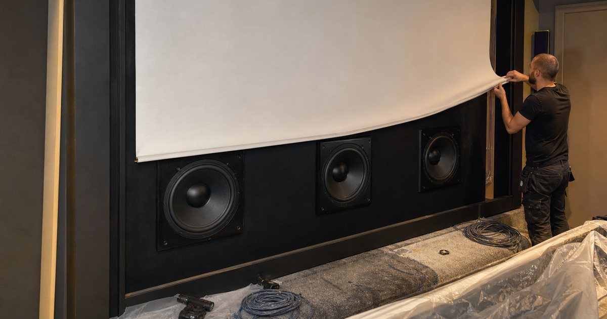 When should a home cinema use an acoustically transparent screen in front of the speakers?